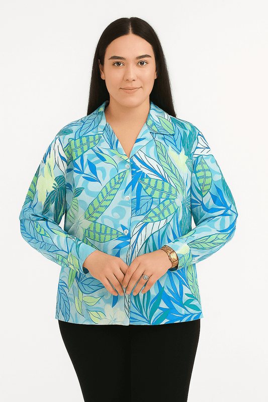Woman wearing a Tropical Breeze Button-Up Shirt with blue leaf print, featuring a relaxed fit and classic collar.
